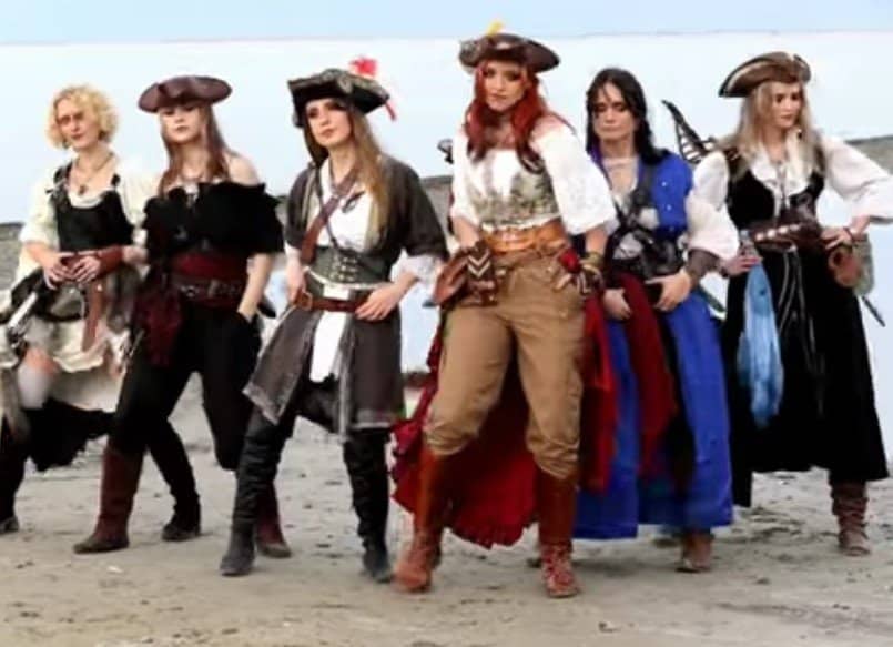 Porpoise scares two kids, and female pirates dance on a beach.